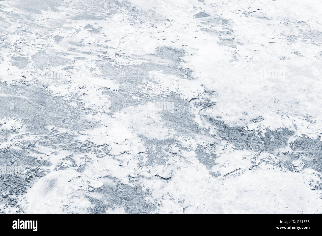 Fresh ice covered with show on frozen river in winter season, natural background photo texture Stock Photo