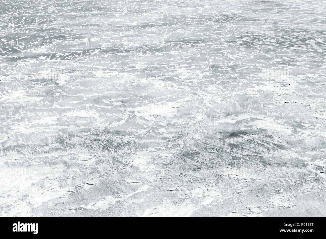 Ice rink covered with show on frozen river in winter season, natural background photo texture Stock Photo