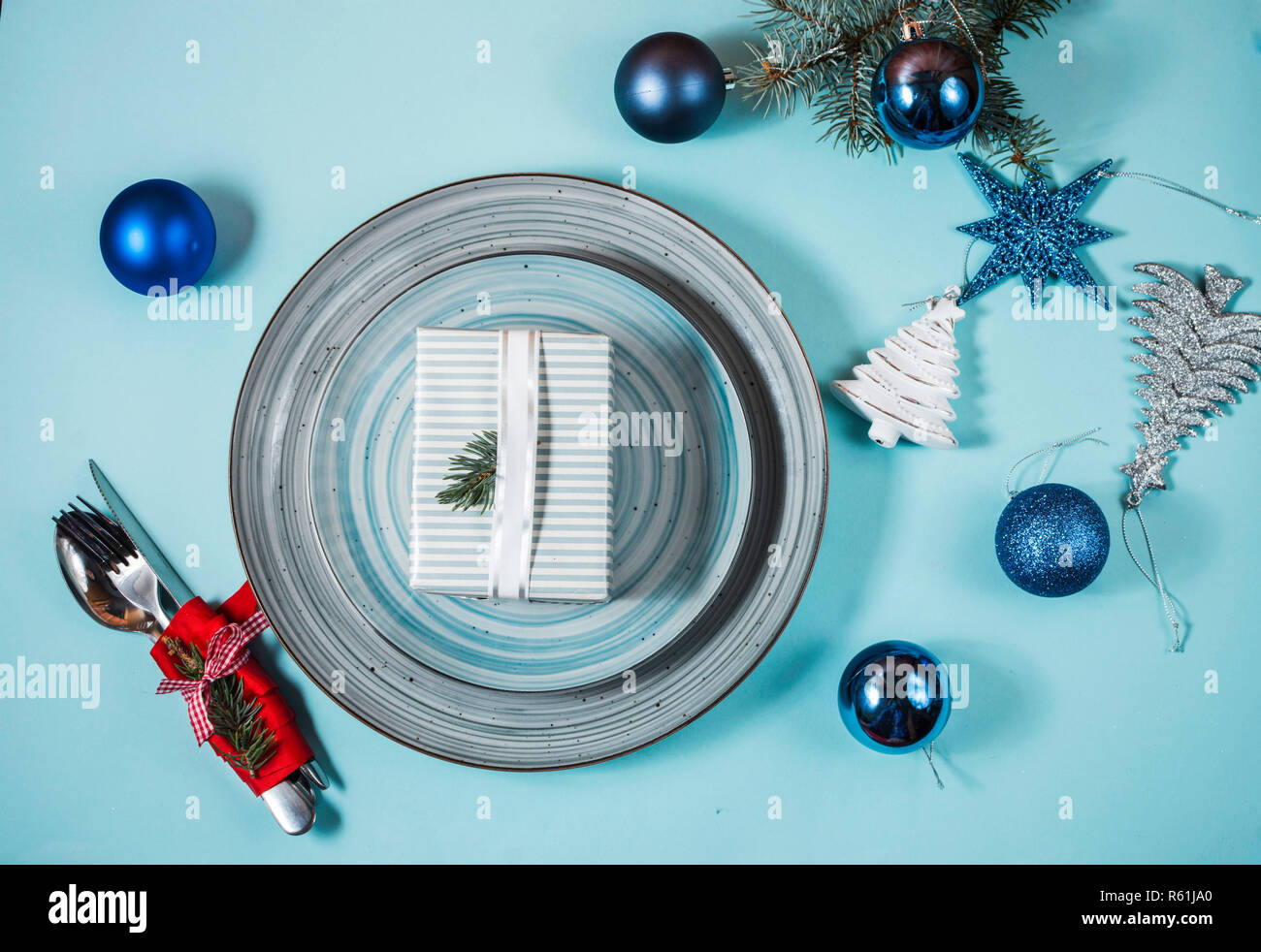 Christmas table place setting on blue background. Holidays background. Stock Photo