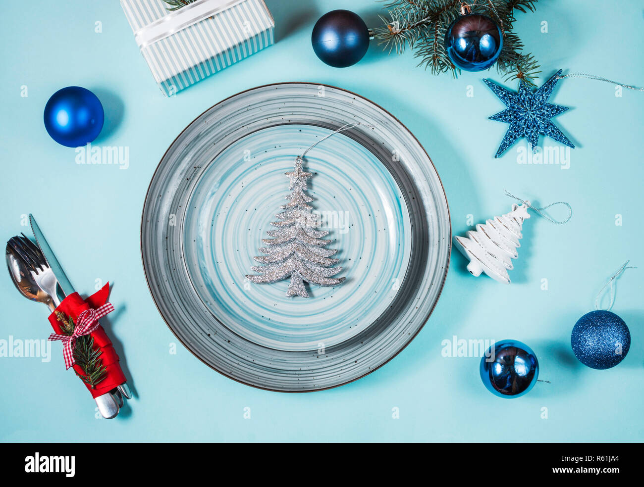Christmas table place setting on blue background. Holidays background. Stock Photo