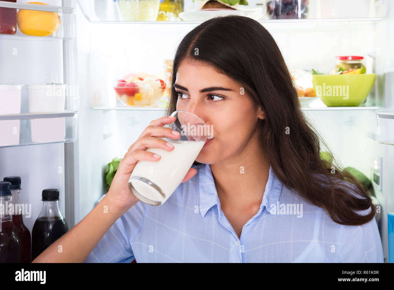 Young Woman Holding Glass Of Milk Stock Photo