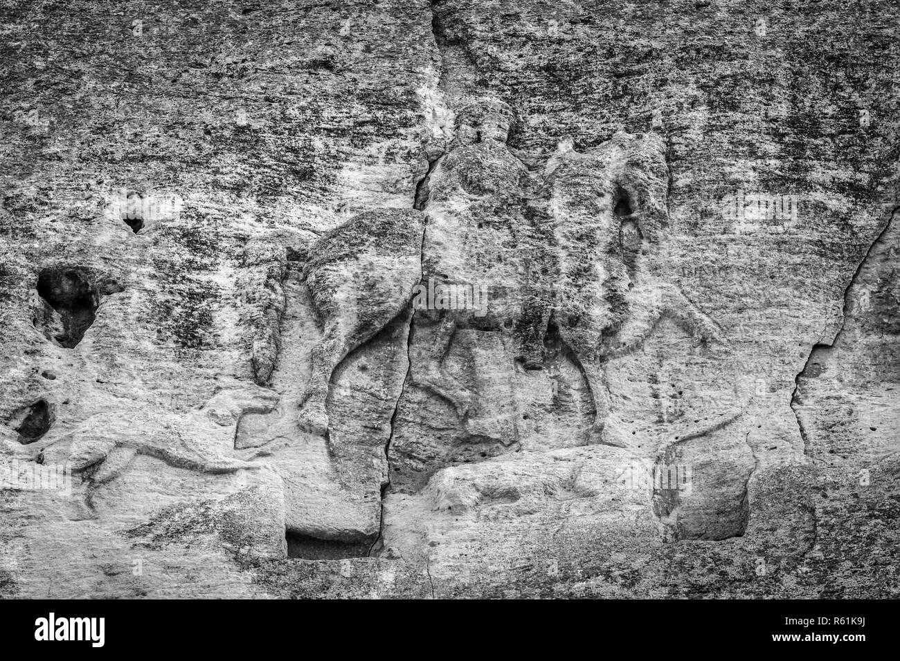 Madara Rider - an archaeological monument of the early Middle Ages (the end of the 7th century), a relief image of a rider carved on a steep rock. Bulgaria. Black and white. Stock Photo