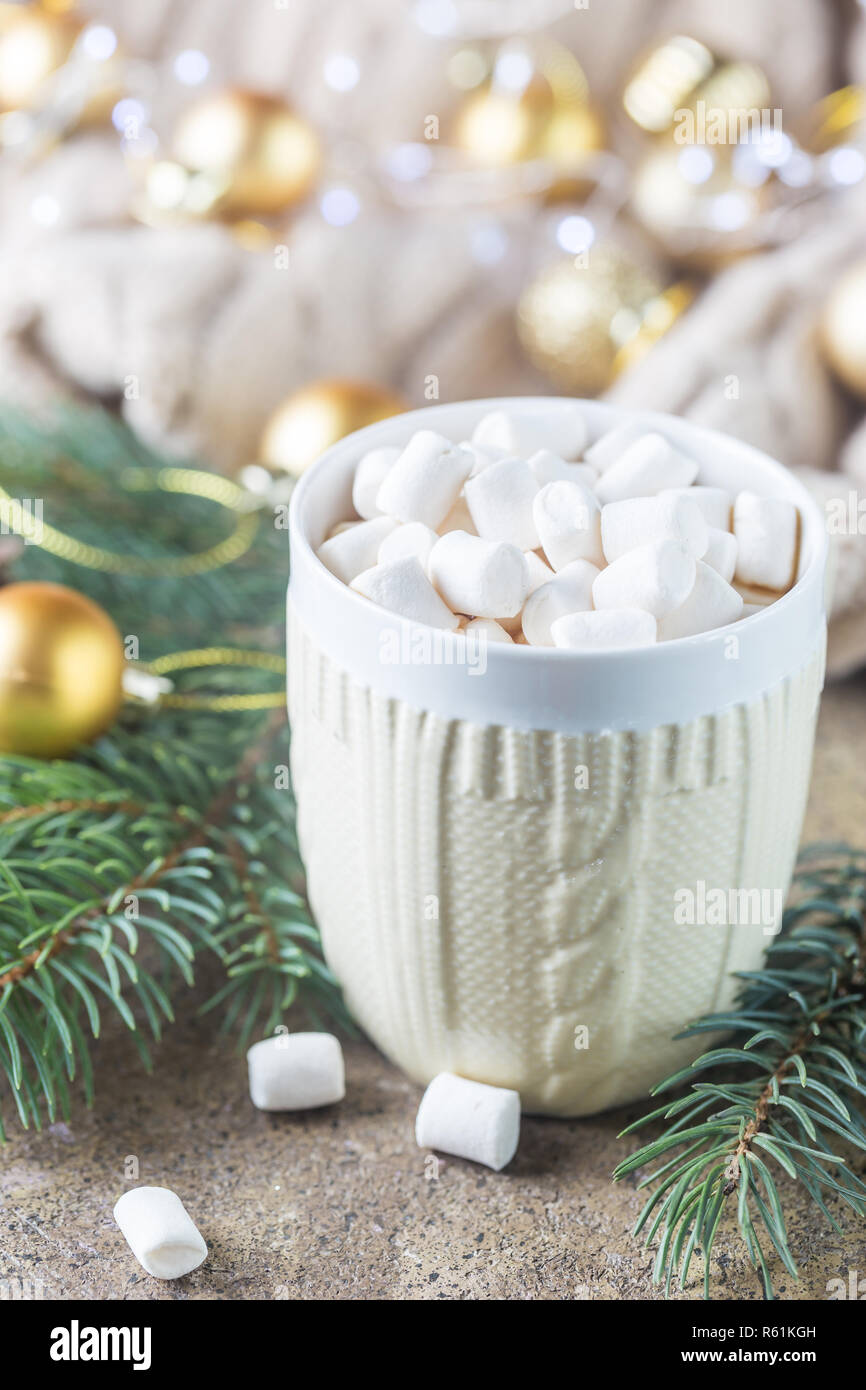 A cup of hot chocolate with marshmallows on a Christmas background