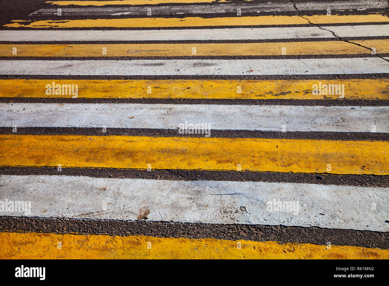 Pedestrian crossing with white and yellow stripes close-up Stock Photo ...