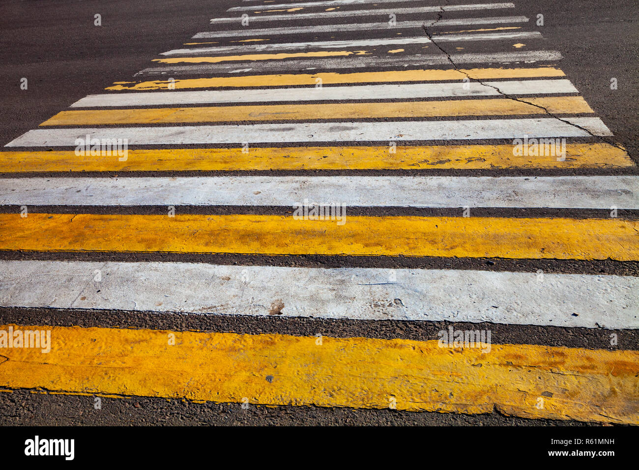 Pedestrian crossing with white and yellow stripes close-up Stock Photo ...