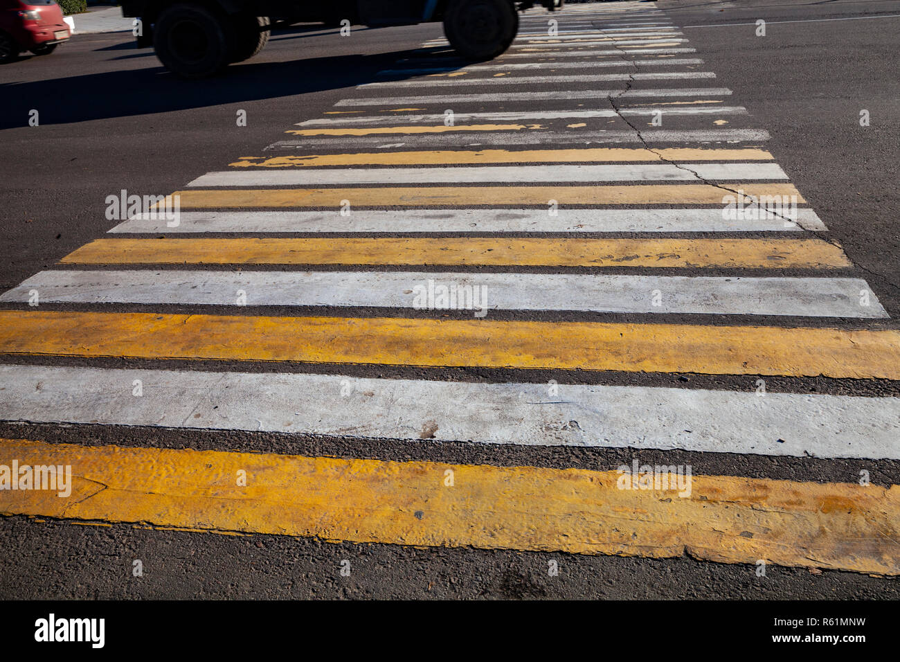 Pedestrian crossing with white and yellow stripes close-up Stock Photo ...