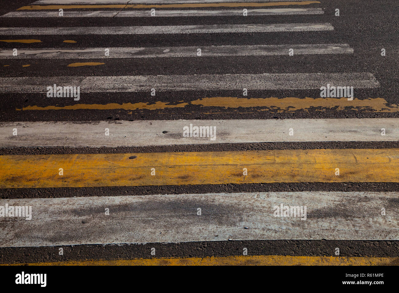 Pedestrian crossing with white and yellow stripes close-up Stock Photo ...