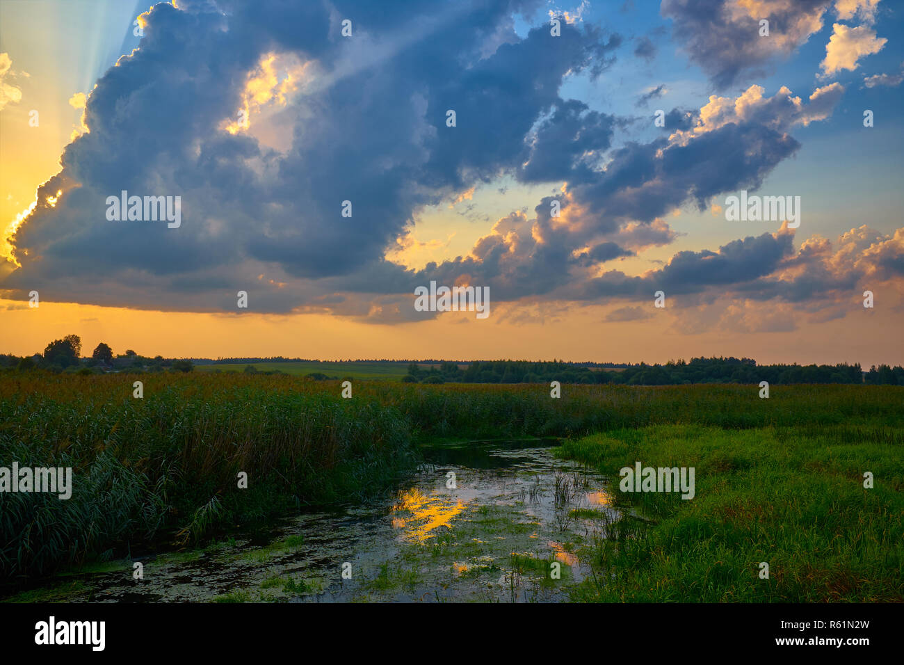 Beautiful sunset on river under cloudy sky. Belarus Stock Photo - Alamy