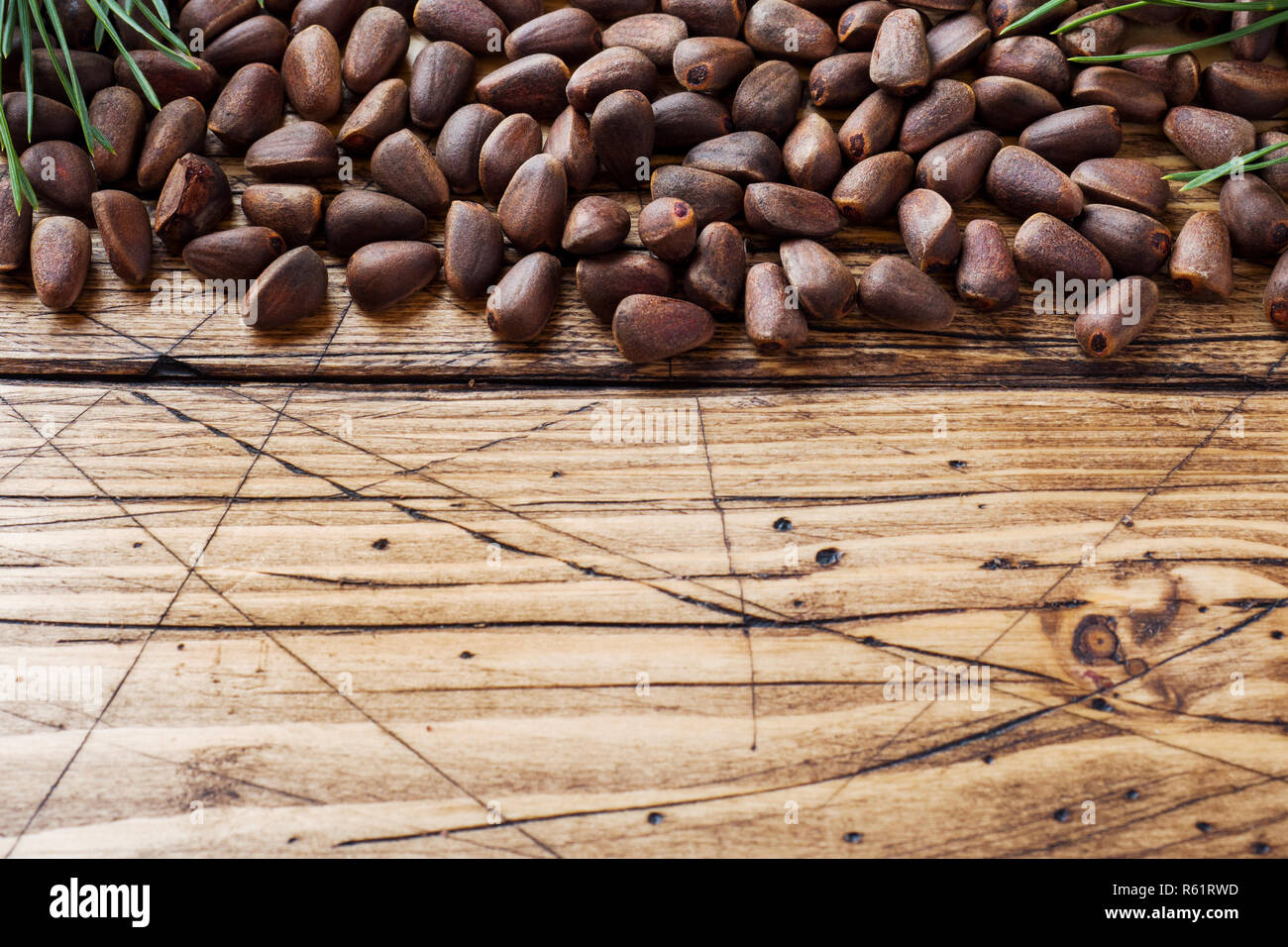 Pine nuts on a wooden background. Selective focus. Copy space. Stock Photo