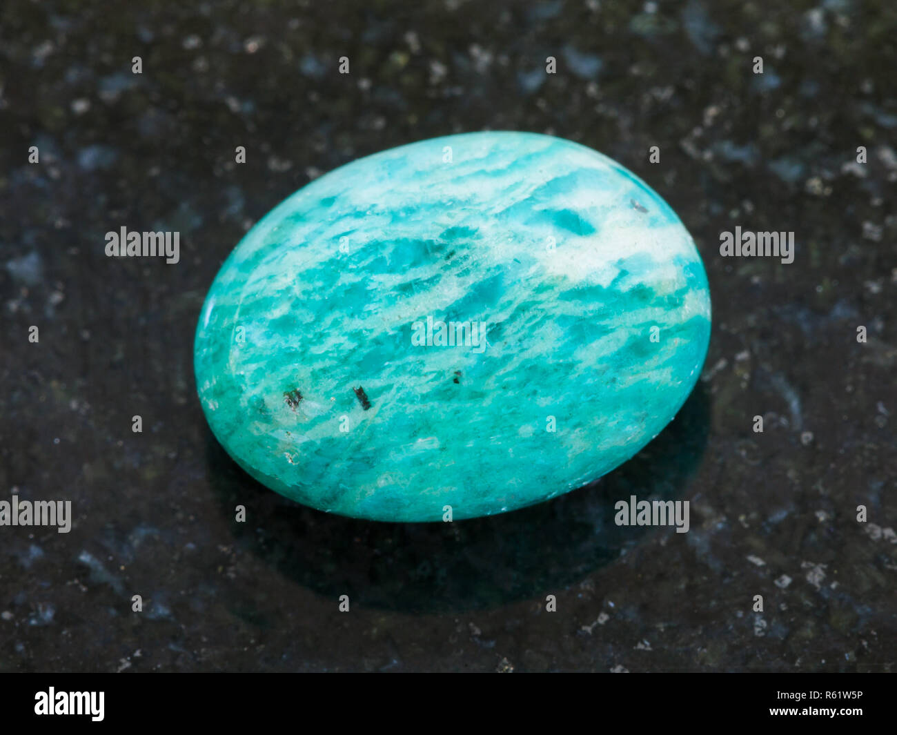polished amazonite gemstone (amazon stone) on dark Stock Photo - Alamy