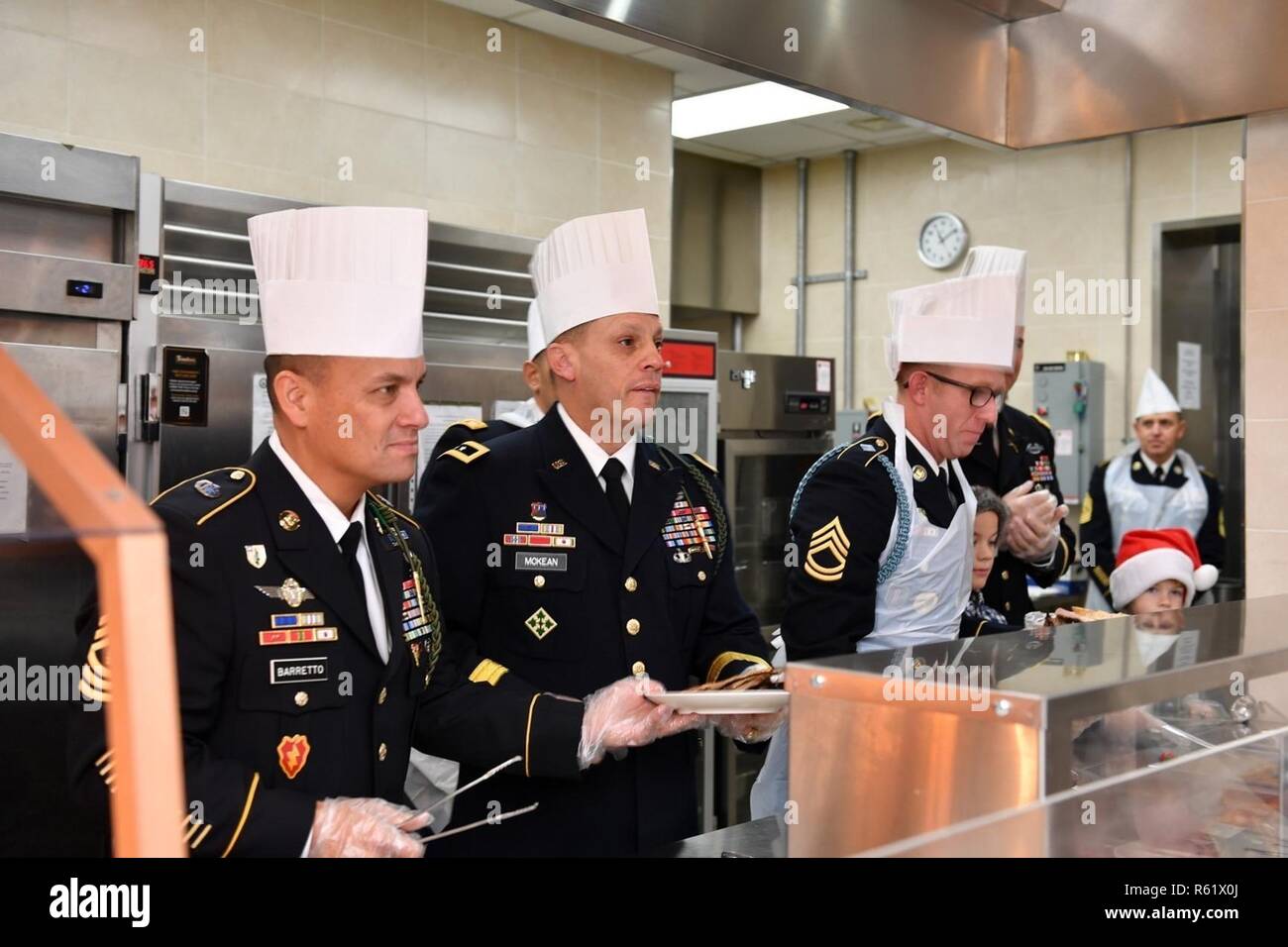 CAMP BONIFAS, Republic of Korea -  Maj. Gen. D. Scott McKean, San Jose, California native, commanding general, 2ID/RUCD and Command Sgt. Maj. Phil K. Barretto, Aiea, Hawaii native, 2ID/RUCD sergeant major serve Thanksgiving meals to Soldiers who are stationed away from home at Bonifas Dining Facility Nov. 22. The command team traveled around the Republic of Korea, ensuring they served meals to as many Warriors as possible, a long-standing military tradition on the holidays where leaders serve their Soldiers to demonstrate appreciation for their hard work and dedication. Stock Photo