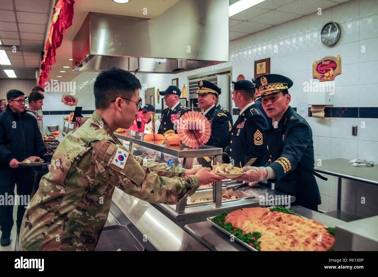 CAMP CASEY, Republic of Korea – Brig. Gen. Kim, Yong Chul, deputy commanding general for ROK, 2nd Infantry Division/ROK-U.S. Combined Division serves traditional Thanksgiving dishes to Soldiers at Casey Main Dining Facility Nov. 22 to demonstrate appreciation for their hard work and dedication. Stock Photo