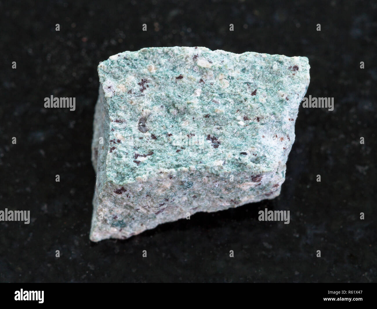 rough Trachyte stone on dark background Stock Photo