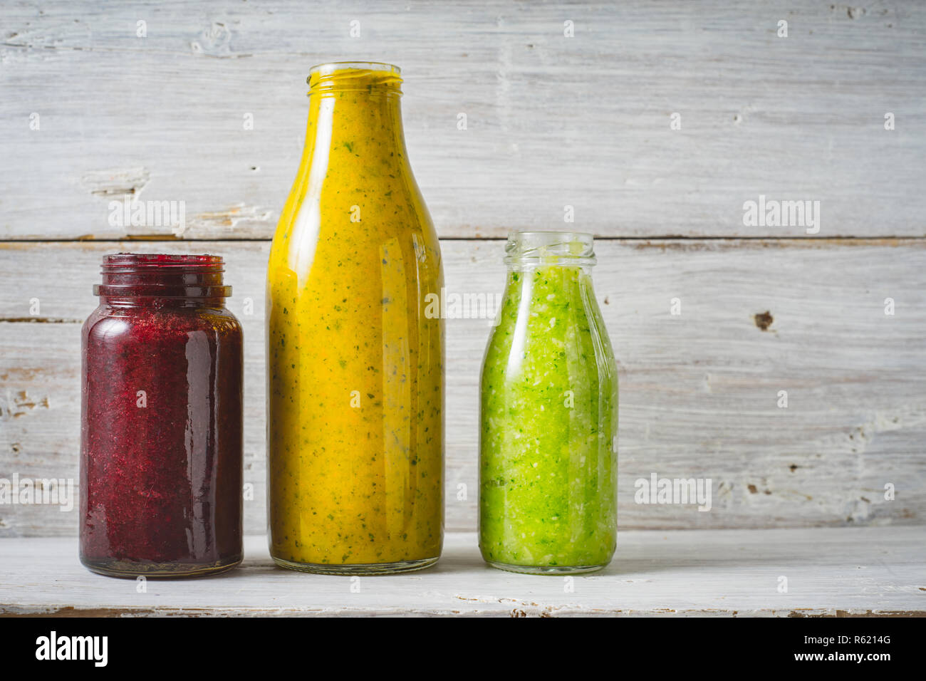 Download Green Yellow And Red Smoothie In The Glass Bottle On The White Wooden Background Stock Photo Alamy PSD Mockup Templates