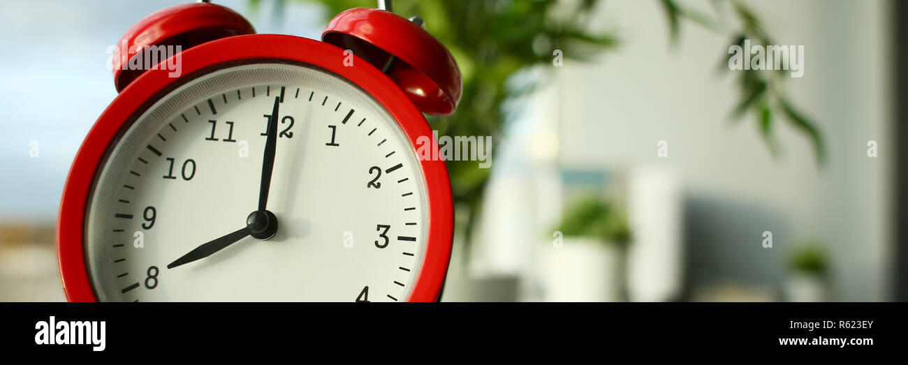 Red alarm clock set at seven in the morning Stock Photo Alamy
