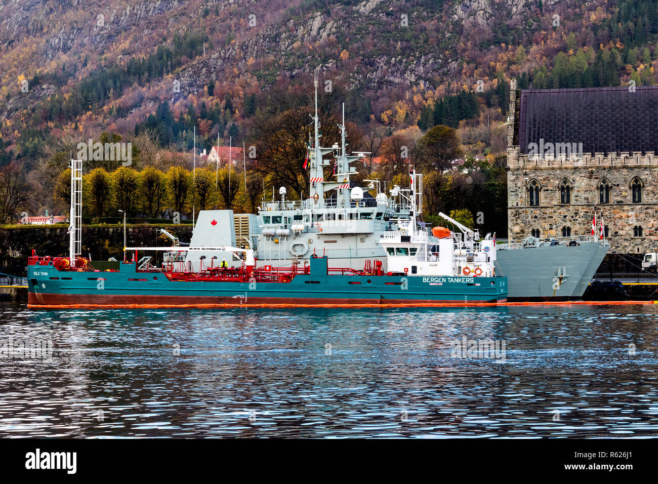 Bunkering vessel Oslo Tank alongside two Canadian navy ships in the port of Bergen, Norway. Haakons Hall in the background. Stock Photo