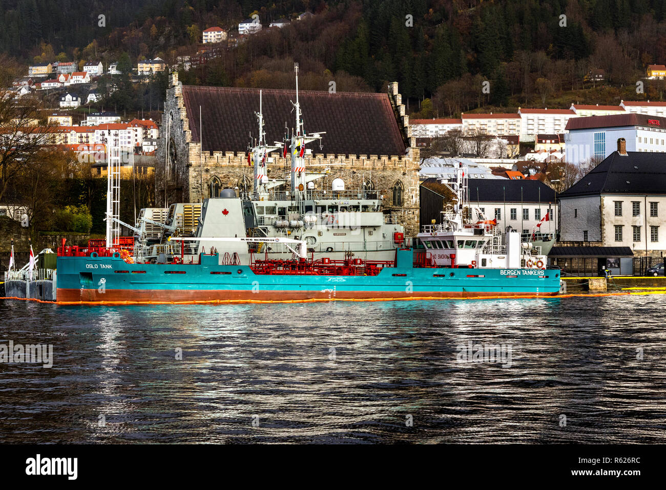 Bunkering vessel Oslo Tank alongside two Canadian navy ships in the port of Bergen, Norway. Haakons Hall and Bergenhus in the background. Stock Photo