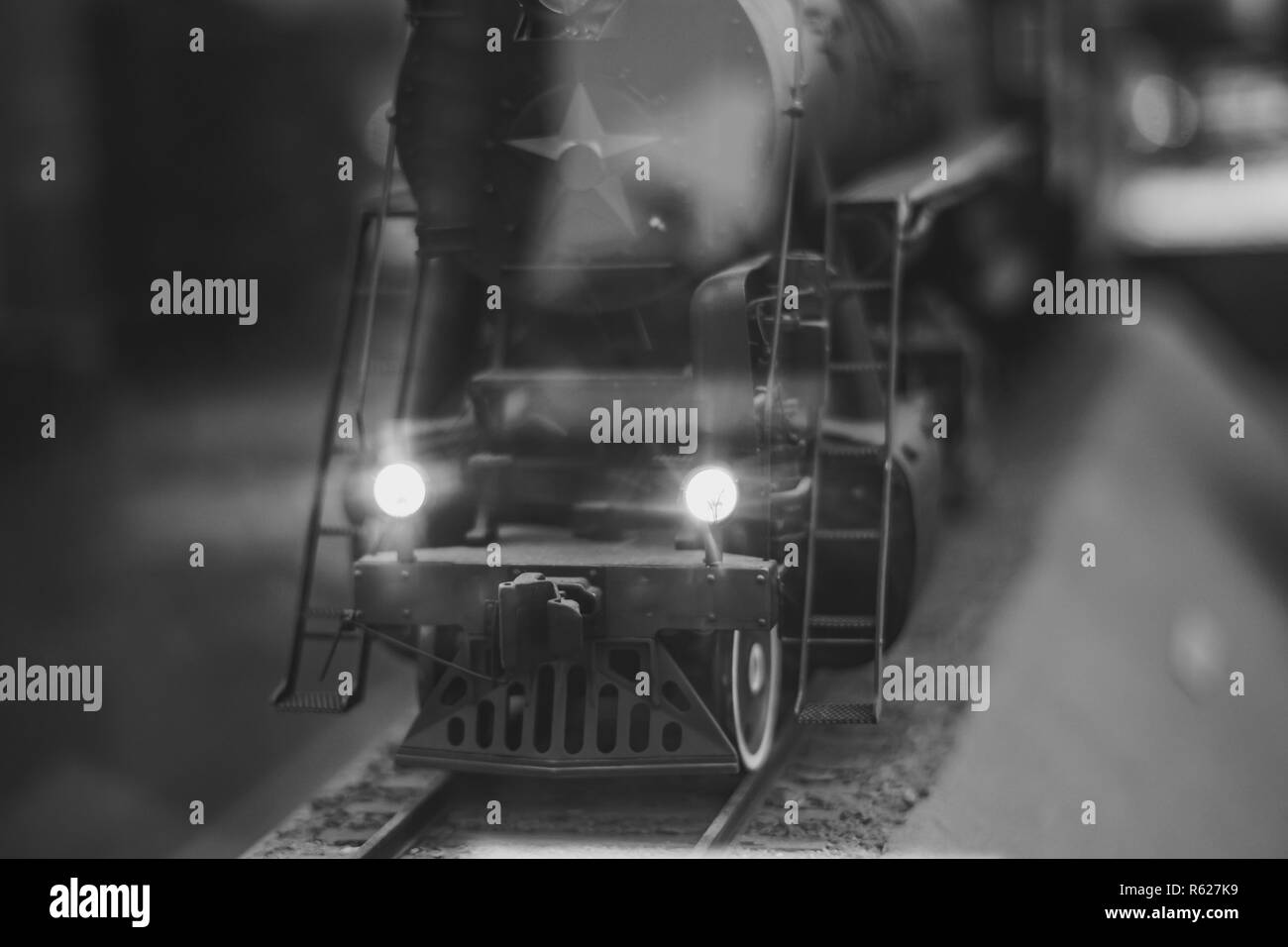 Black model Locomotive on track layout with headlamp Stock Photo - Alamy