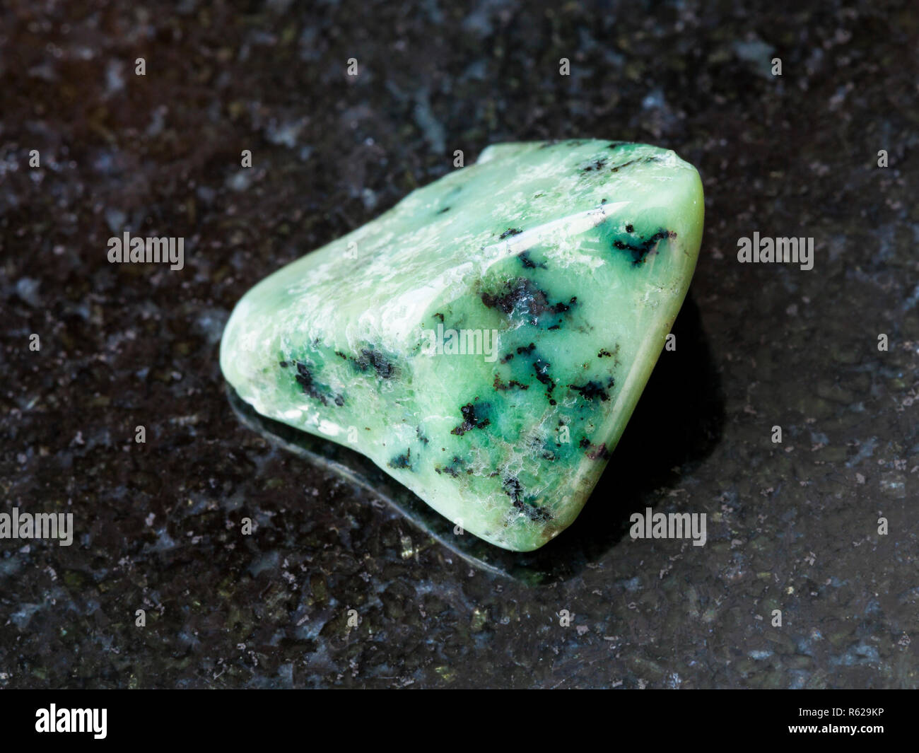 tumbled green Grossular gemstone on dark Stock Photo Alamy