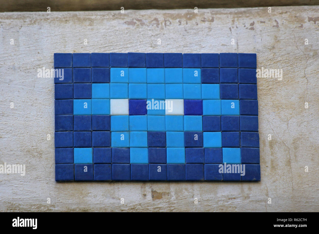 Invader or space invader art street mosaic on a wall by the Trevi Fountain in Rome, Italy by the French urban artist known as Invader Stock Photo