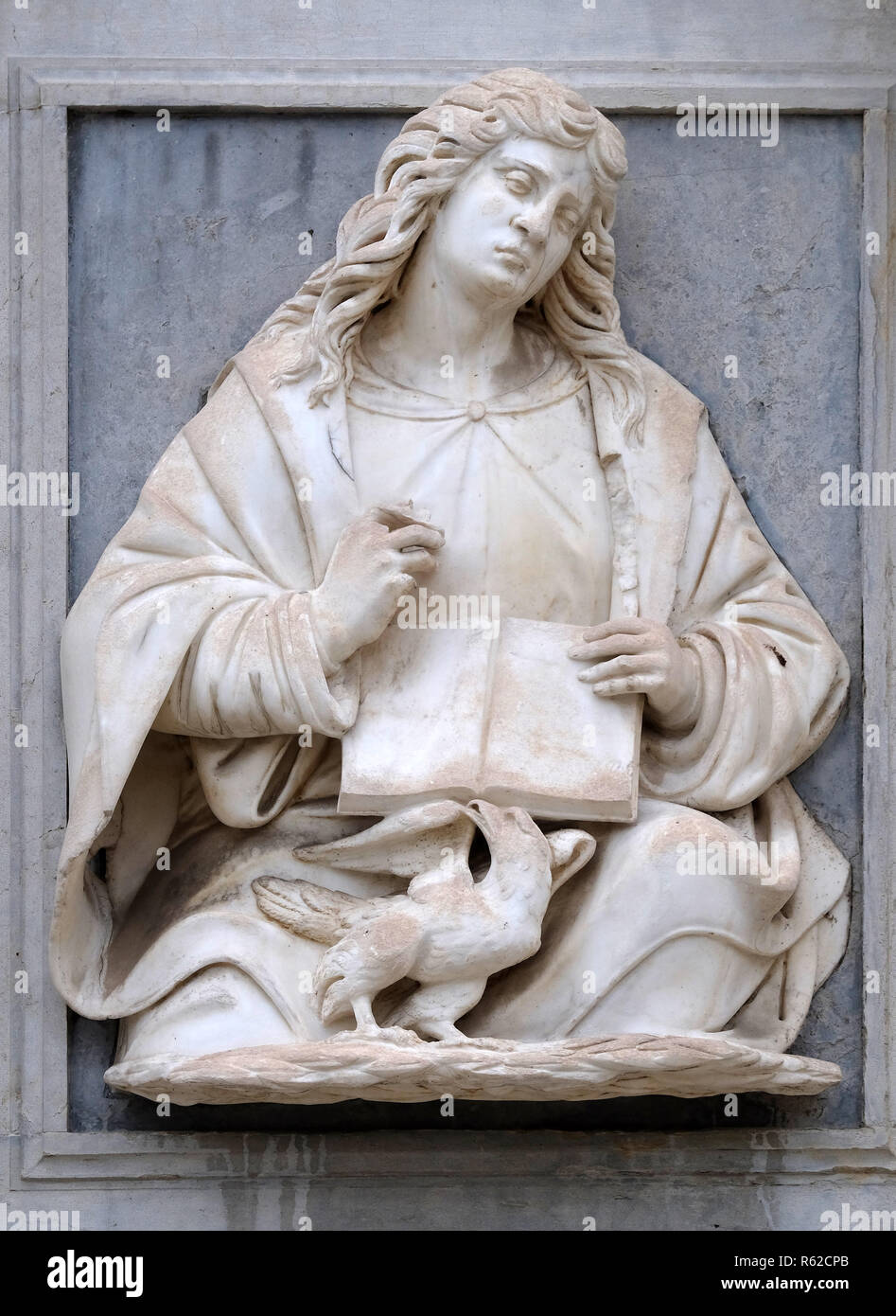 Saint John the Evangelist relief on the portal of the Cathedral of Saint Lawrence in Lugano, Switzerland Stock Photo