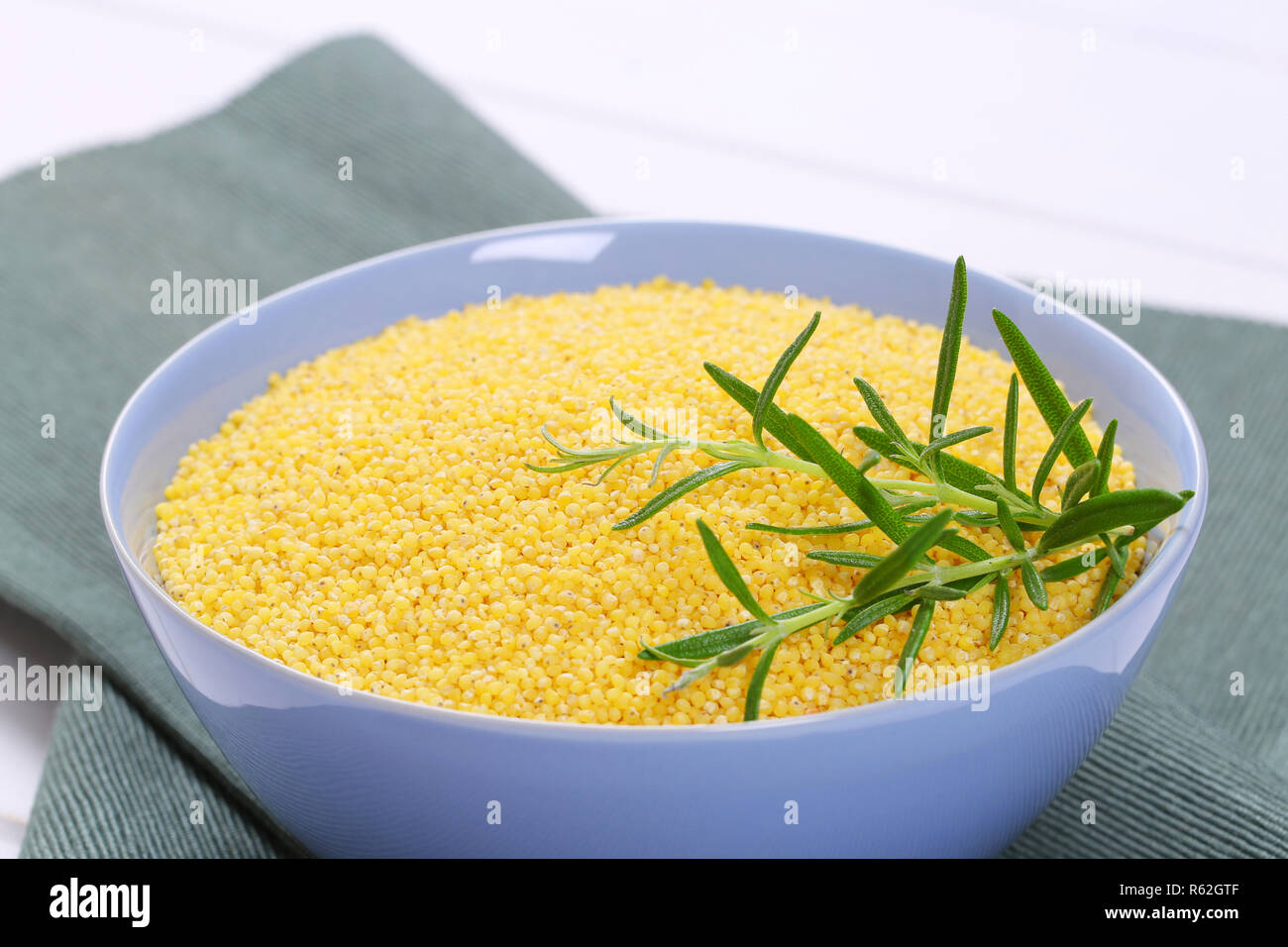 bowl of raw millet grain Stock Photo Alamy