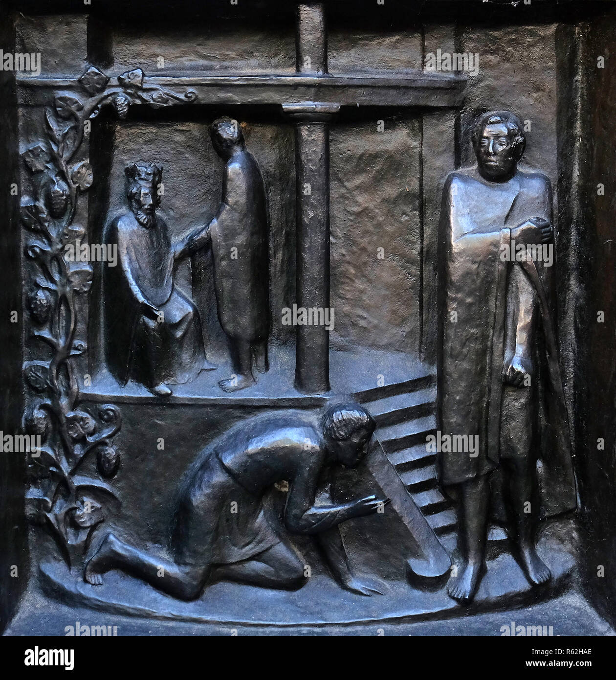 Forgive us our debts - the parable of the unforgiving servant, relief on the door of the Grossmunster ('great minster') church in Zurich, Switzerland Stock Photo