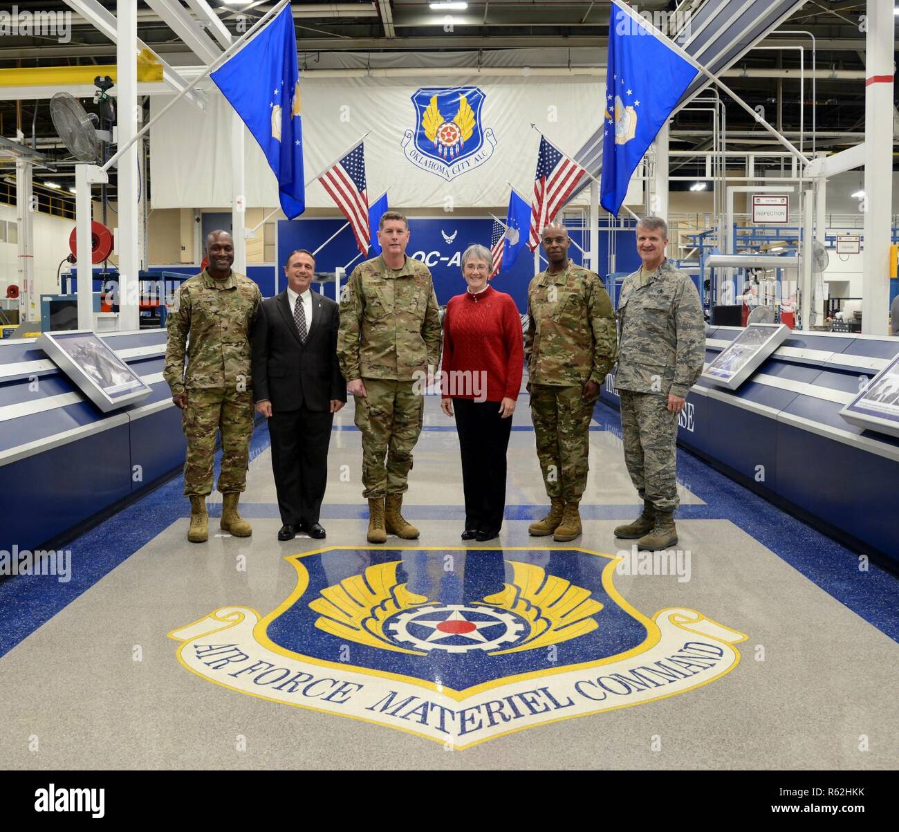 Col. Kenyon Bell, 72nd Air Base Wing commander; Kevin Stamey, Air Force Sustainment Center executive director; Lt. Gen. Gene Kirkland, AFSC commander; Secretary of the Air Force Heather Wilson; Maj. Gen. Cedric George, director of Logistics, deputy chief of staff for Logistics, Engineering and Force Protection and Brig. Gen. Chris Hill, Oklahoma City Air Logistics Complex commander pose for a photo with the Air Force Materiel Command emblem located at Hollywood and Vine in Bldg. 3001. Wilson visited Tinker Nov. 16 and toured several facilities and organizations. She announced at the end of her Stock Photo