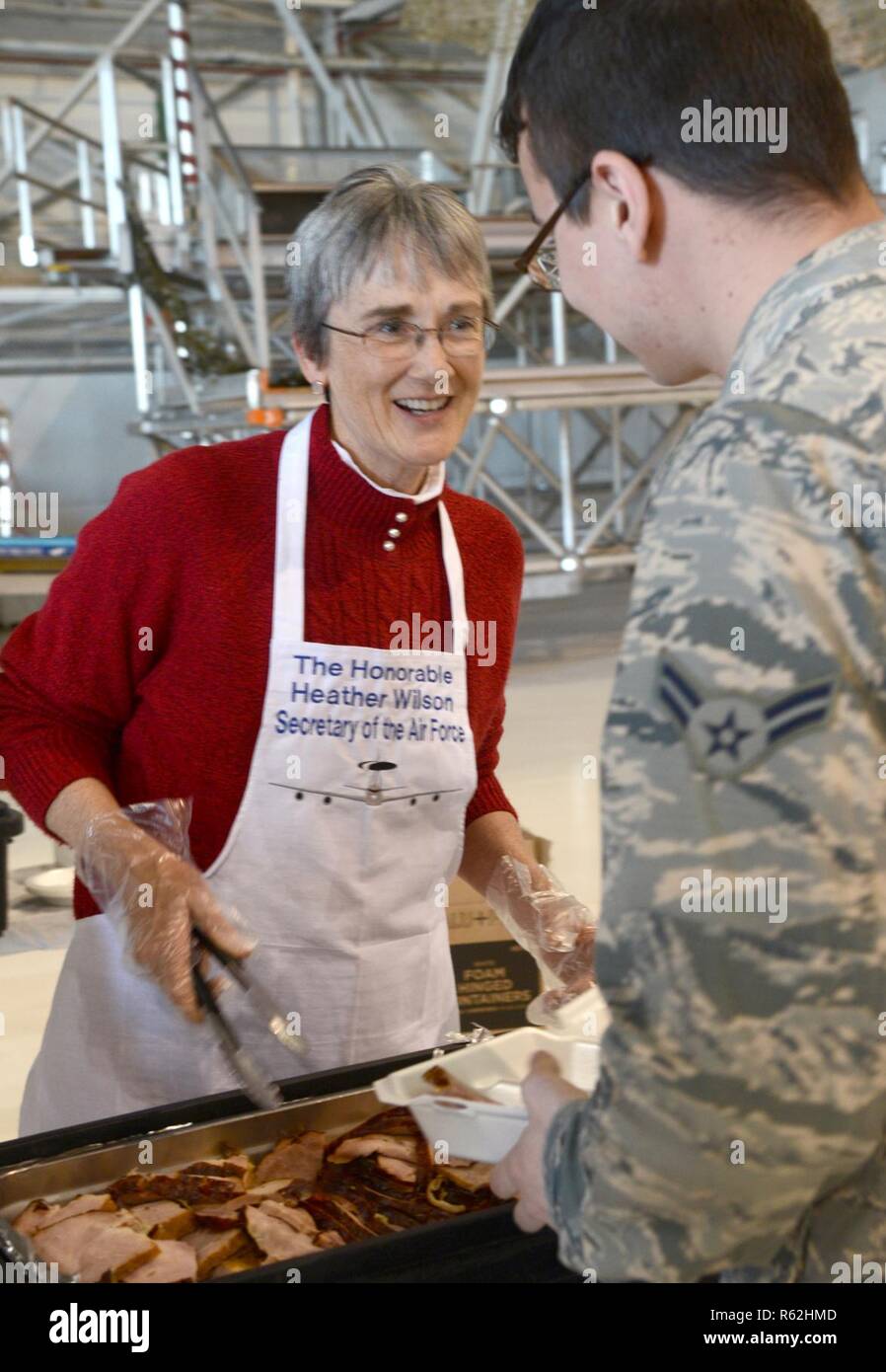 Secretary of the Air Force Heather Wilson took the opportunity to help serve Thanksgiving dinner to members of the 552nd Air Control Wing during her visit to Tinker Air Force Base Nov. 16. Wilson is shown here serving ham-slices to an Airman 1st Class of the 552nd ACW. Stock Photo