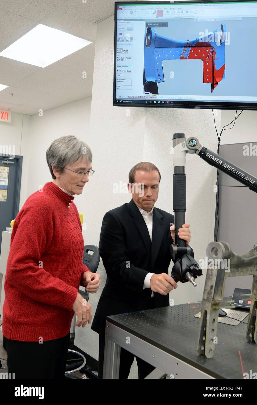 Nathan Pitcovich, Reverse Engineering and Critical Tooling Lab engineer, demonstrates a Romer Arm, which scans parts, to Secretary of the Air Force Heather Wilson, during her visit to Tinker Air Force Base Nov. 16. Wilson toured centers for innovation like the REACT lab and met with personnel responsible for sustaining the Air Force’s fleet of tanker, bomber and transport aircraft. Stock Photo