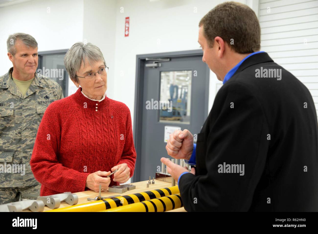 Secretary of the Air Force Heather Wilson listens as Marty Williams, Reverse Engineering and Critical Tooling Lab flight chief, shows her several parts that engineers in the lab have made using 3-D printing processes. 3-D printing is saving the Air Force large sums for critical parts that are no longer produced at reasonable costs to the taxpayers. Stock Photo