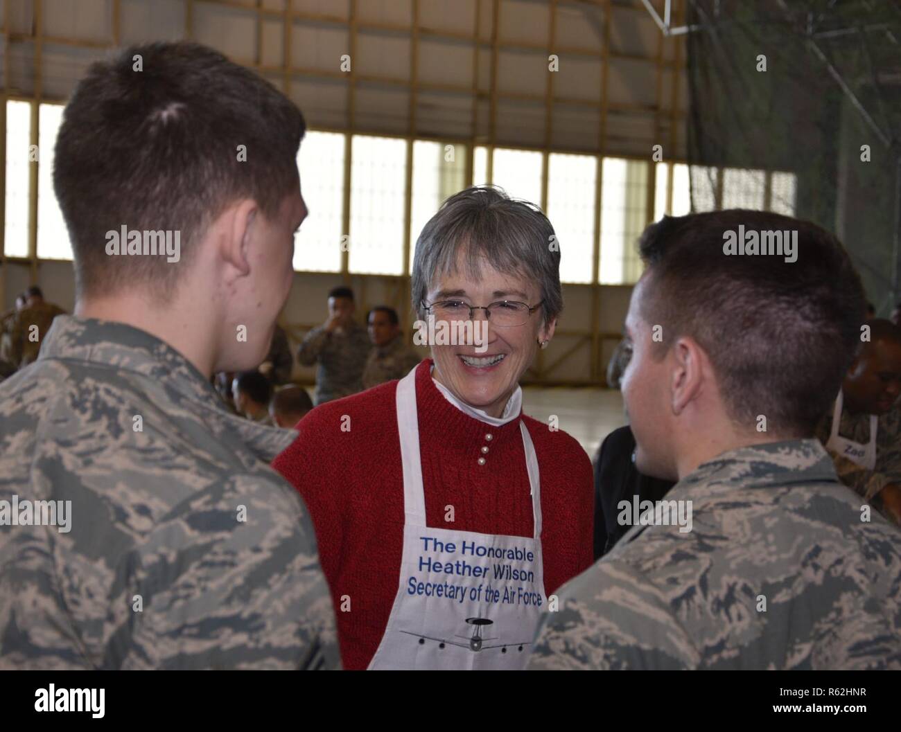 Secretary of the Air Force Heather Wilson talks to a couple of airmen from the 552nd Air Control Wing at the 552nd Maintenance Group Turkey Day, held in Dock 2, Hangar 230, Nov 16, 2018.  The Secretary thanked the men and women of the 552nd ACW and helped senior leadership serve a Thanksgiving meal. Stock Photo