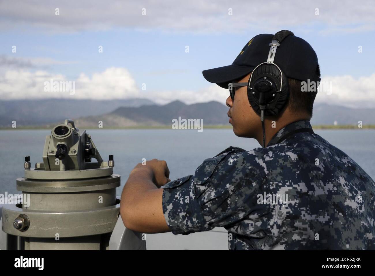 181121-N-DX072-1061 CAIRNS, Australia (Nov. 21, 2018) Quartermaster Seaman Vincentius Clark, from Jakarta, Indonesia, stands starboard bridge-wing lookout watch during a sea and anchor evolution as the amphibious transport dock ship USS Green Bay (LPD 20) arrives in Cairns, Australia for a port visit. Green Bay, part of Commander Amphibious Squadron 11, is operating in the region to enhance interoperability with partners and serve as a ready-response force for any type of contingency. Stock Photo