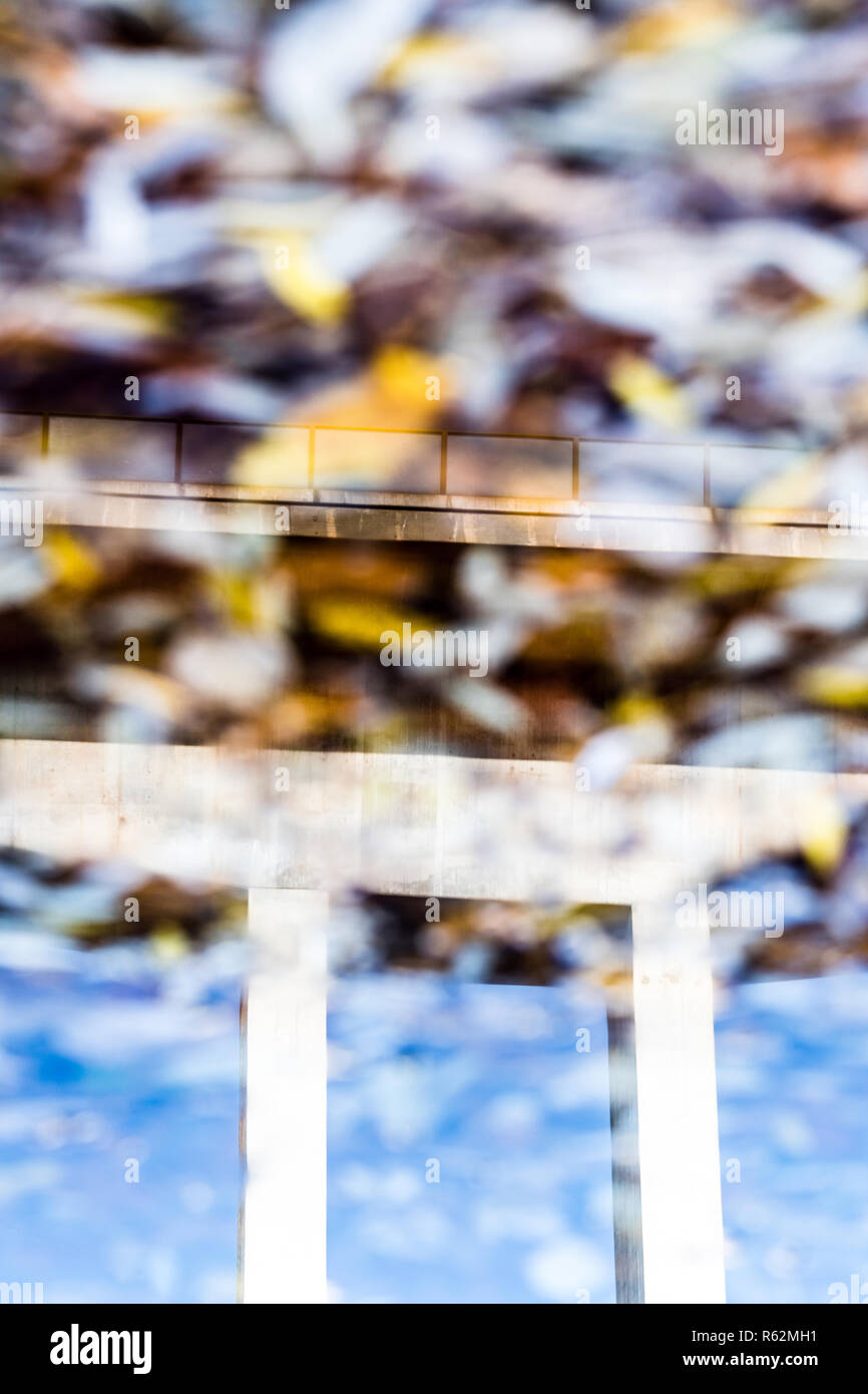 highway bridge mirrored in water in autumn, bern, switzerland Stock Photo