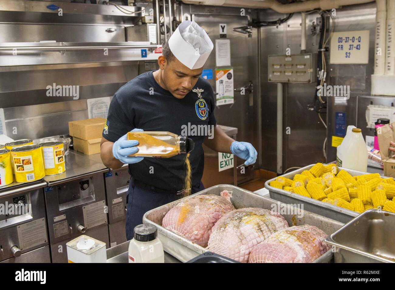 Pacific Ocean Nov 22 2018 Culinary Specialist 1st Class Desmond Moore Seasons Ham Being Prepared For Thanksgiving Dinner Aboard The Amphibious Dock Landing Ship Uss Ashland Lsd 48 Ashland Assigned To Commander