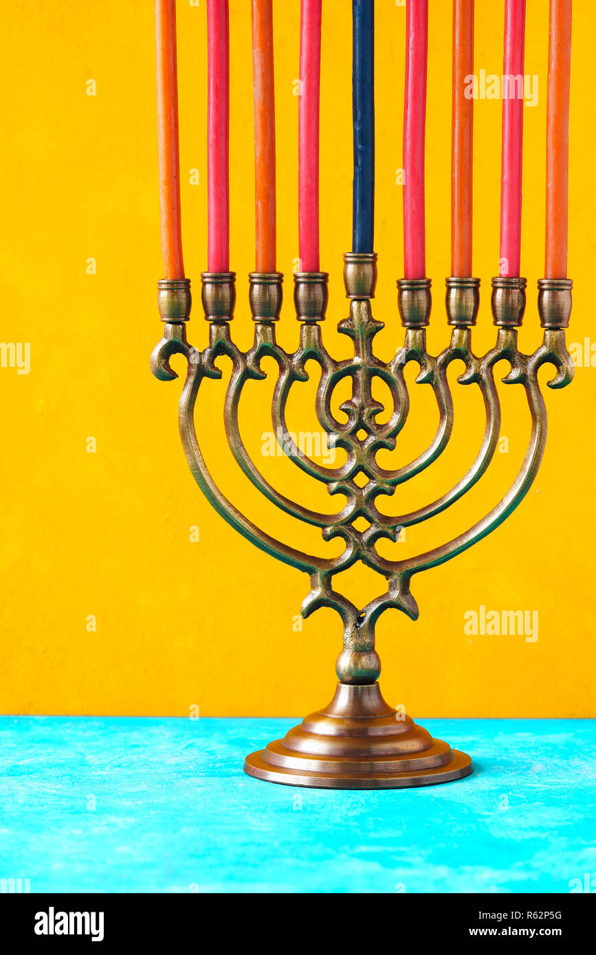 Hanukkah menorah with candles on the yellow background vertical Stock