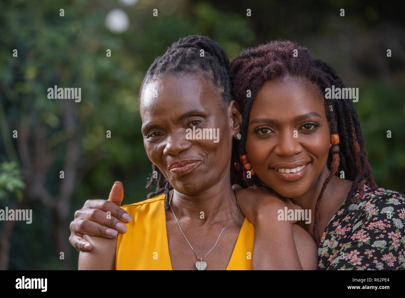 Closeup of a woman and her mother in a garden Stock Photo