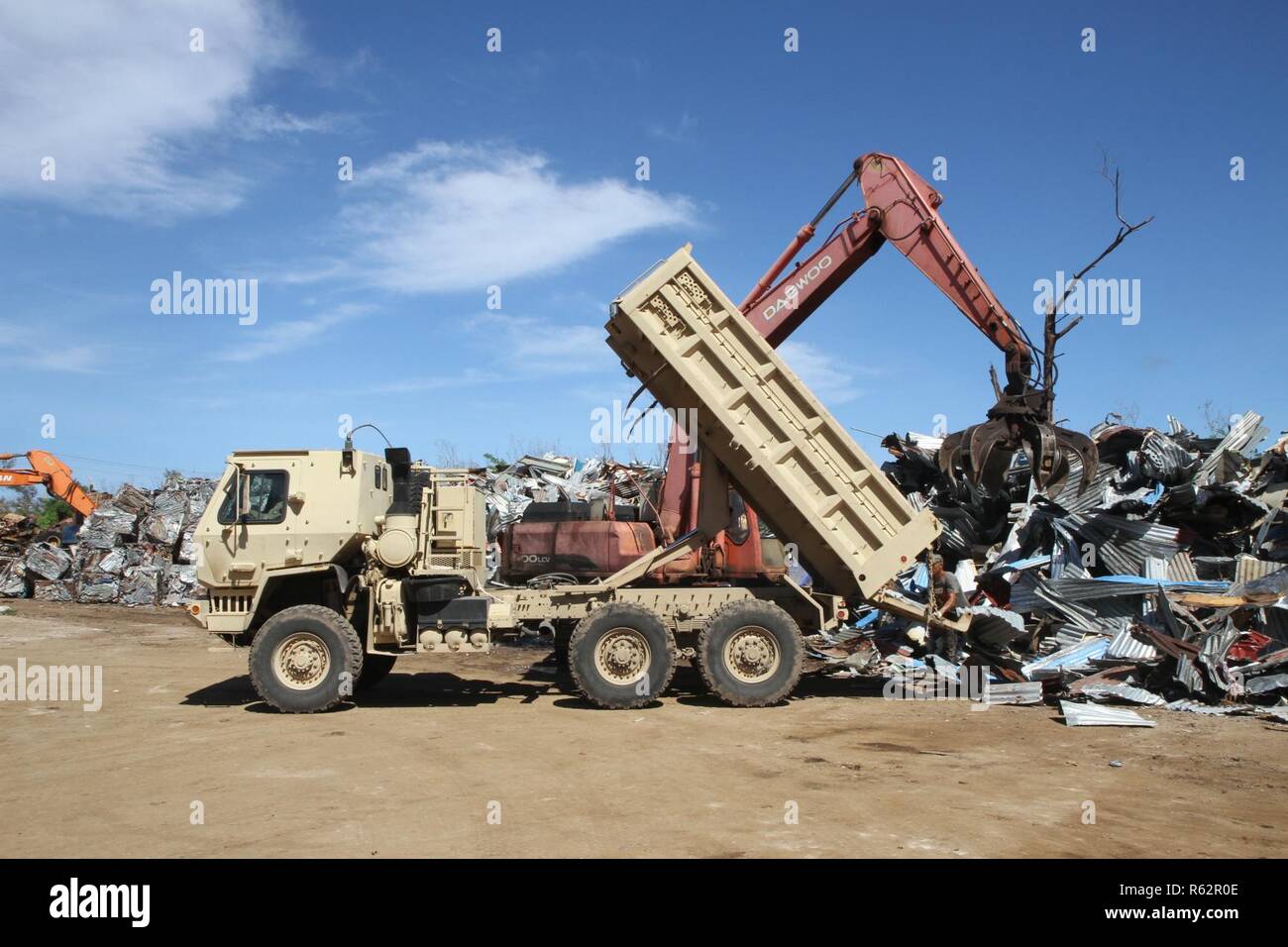 A Guam Army National Guardsman raises the bed of a military tactical