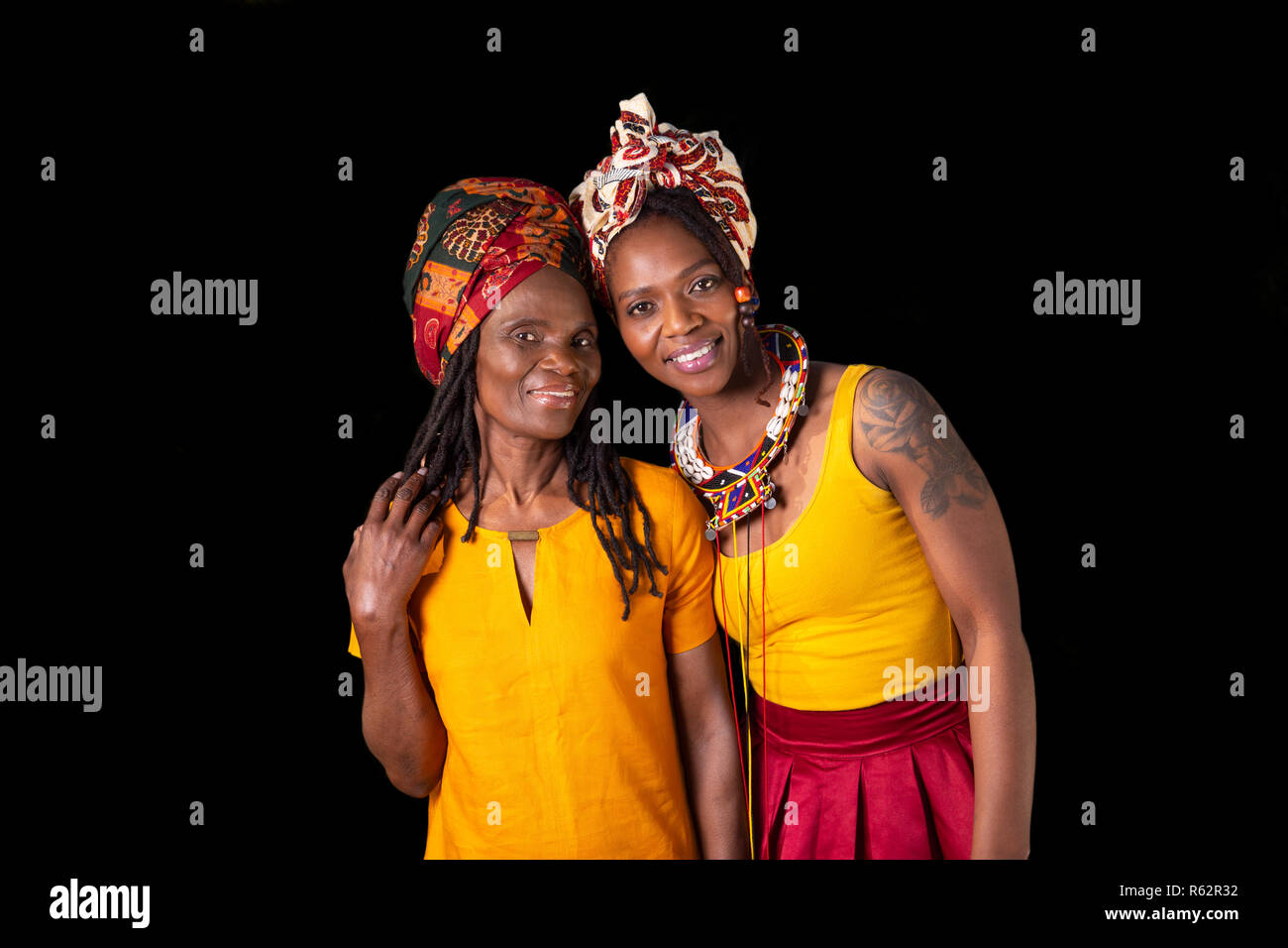 Two African women in headscarves against a black background Stock Photo