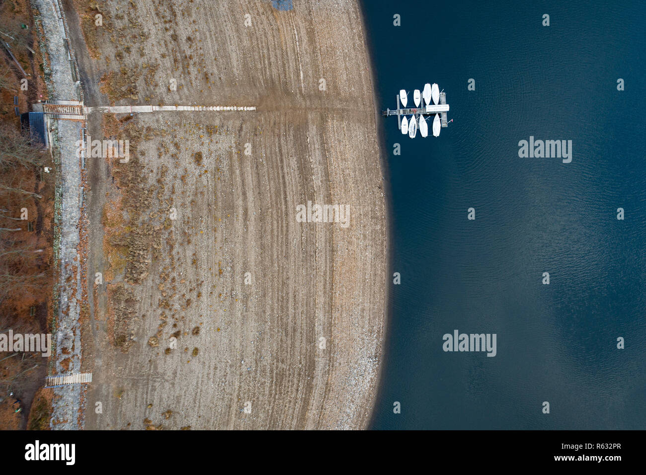 Waldeck, Germany. 03rd Dec, 2018. Boats are moored at a jetty in the low tide of the Eder reservoir. The Ederstausee is the third largest reservoir in Germany in terms of volume. (Aerial photograph with drone) Credit: Swen Pförtner/dpa/Alamy Live News Stock Photo