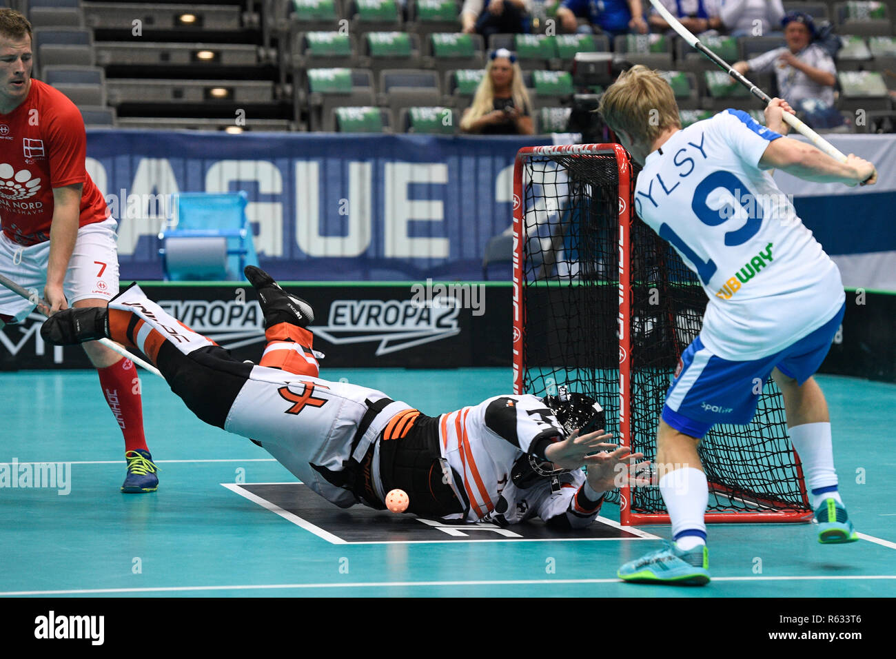 Prague, Czech Republic. 03rd Dec, 2018. Left to right floorball players  ANDERS HOLM (DK), MIKE TROLLE (DK) and JOONAS PYLSY (FIN) in action during  the Men's World Floorball Championship group B match
