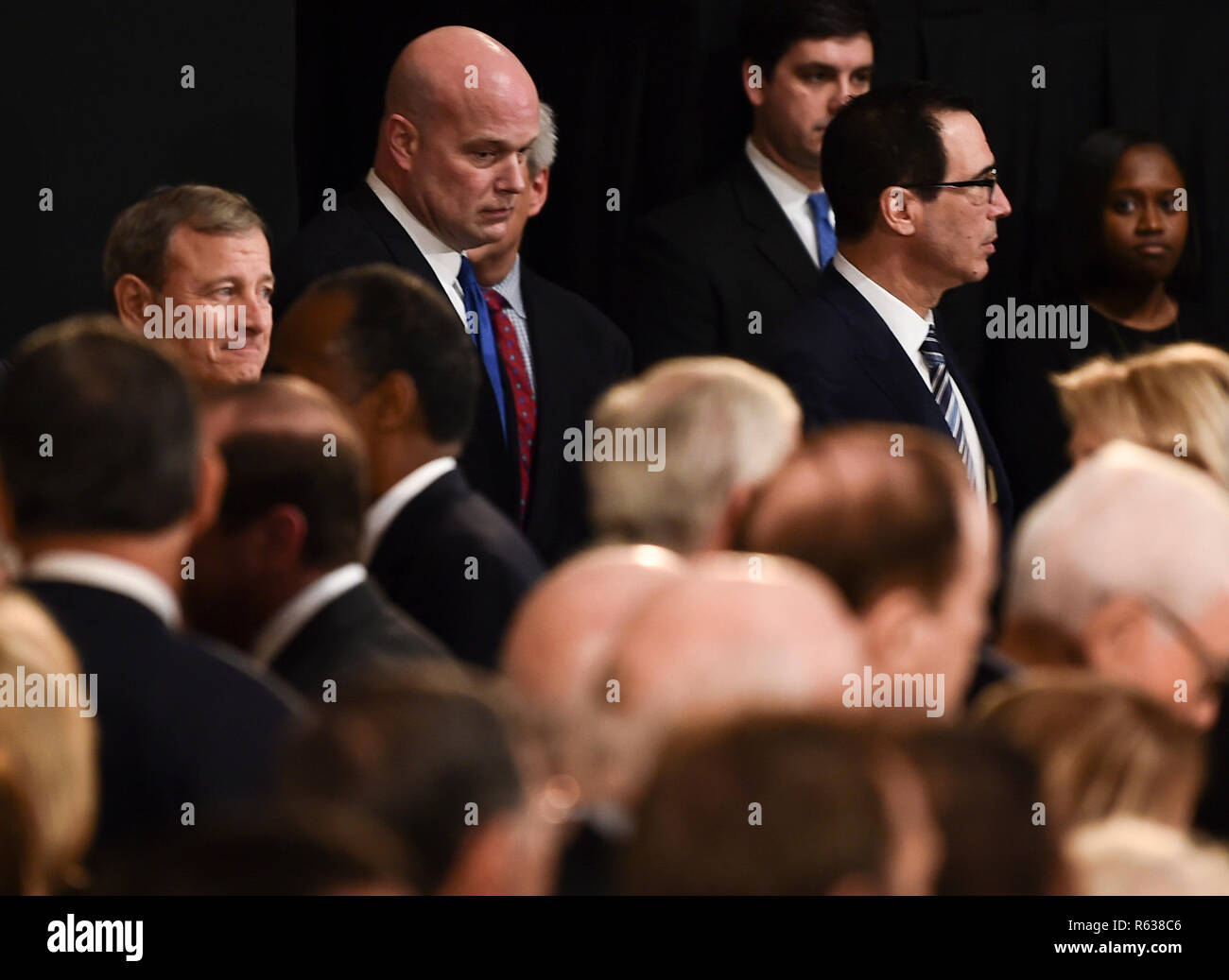 Member of the Supreme Court Chief Justice, John Roberts (L), acting Attorney General, Matthew Whitaker (C), and Secretary of the Treasury, Steven Mnuchin (L) wait for the casket containing the remains of former US President George H.W. Bush to arrive at the US Capitol during a State Funeral in Washington, DC, December 3, 2018. - The body of the late former President George H.W. Bush will travel from Houston to Washington, where he will lie in state at the US Capitol through Wednesday morning. Bush, who died on November 30, will return to Houston for his funeral on Thursday. (Photo by Brendan Stock Photo