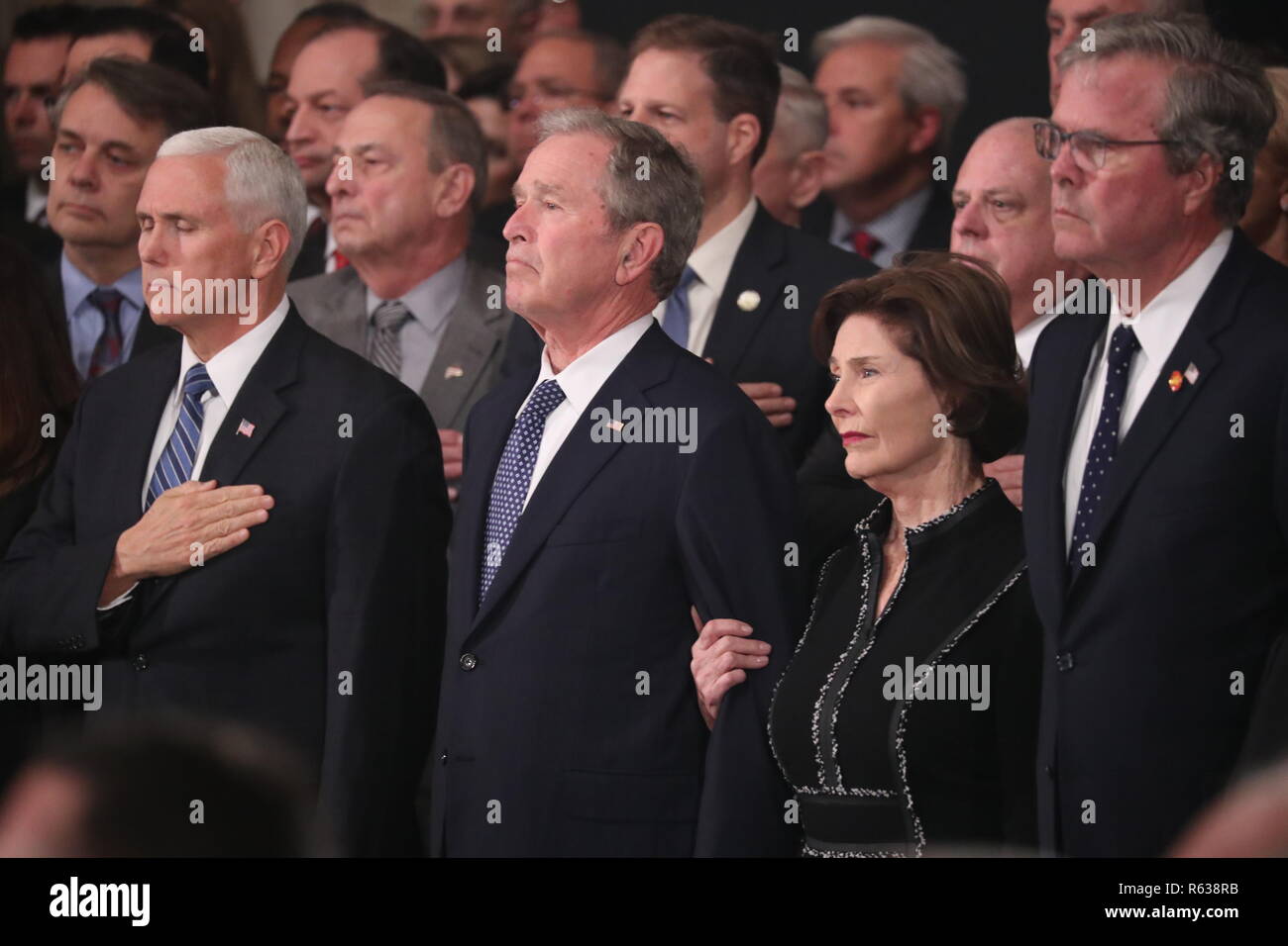 Washington, United States Of America. 03rd Dec, 2018. U.S. Vice President Mike Pence, former President George W. Bush, former first lady Laura Bush and former Florida Governor Jeb Bush watch as the casket of former President George H.W. Bush arrives to lie in state in the U.S. Capitol Rotunda in Washington, U.S., December 3, 2018. REUTERS/Jonathan Ernst/Pool | usage worldwide Credit: dpa/Alamy Live News Stock Photo