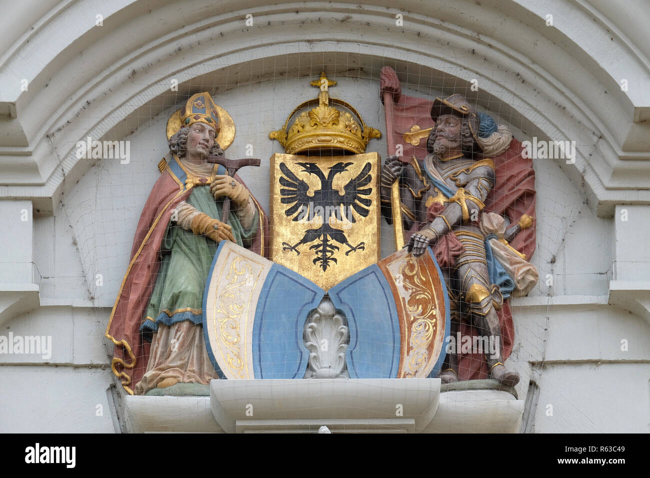 The crests of Lucerne and the Imperial Eagle above entranceway are flanked by the St Leodegar and St Maurice, church of St. Leodegar in Lucerne Stock Photo