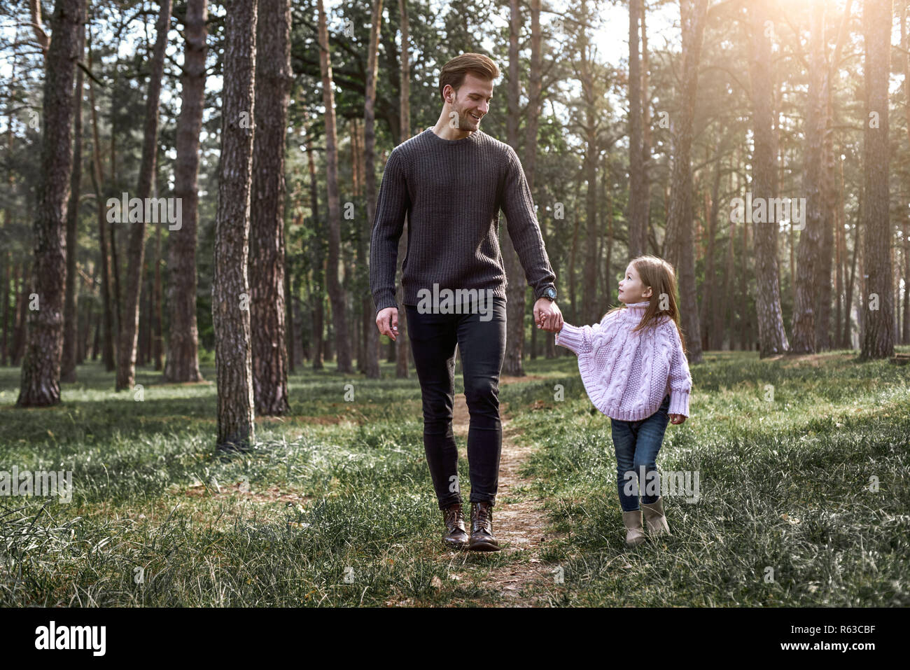 Father and daughter walking together in the forest. Full length Stock ...