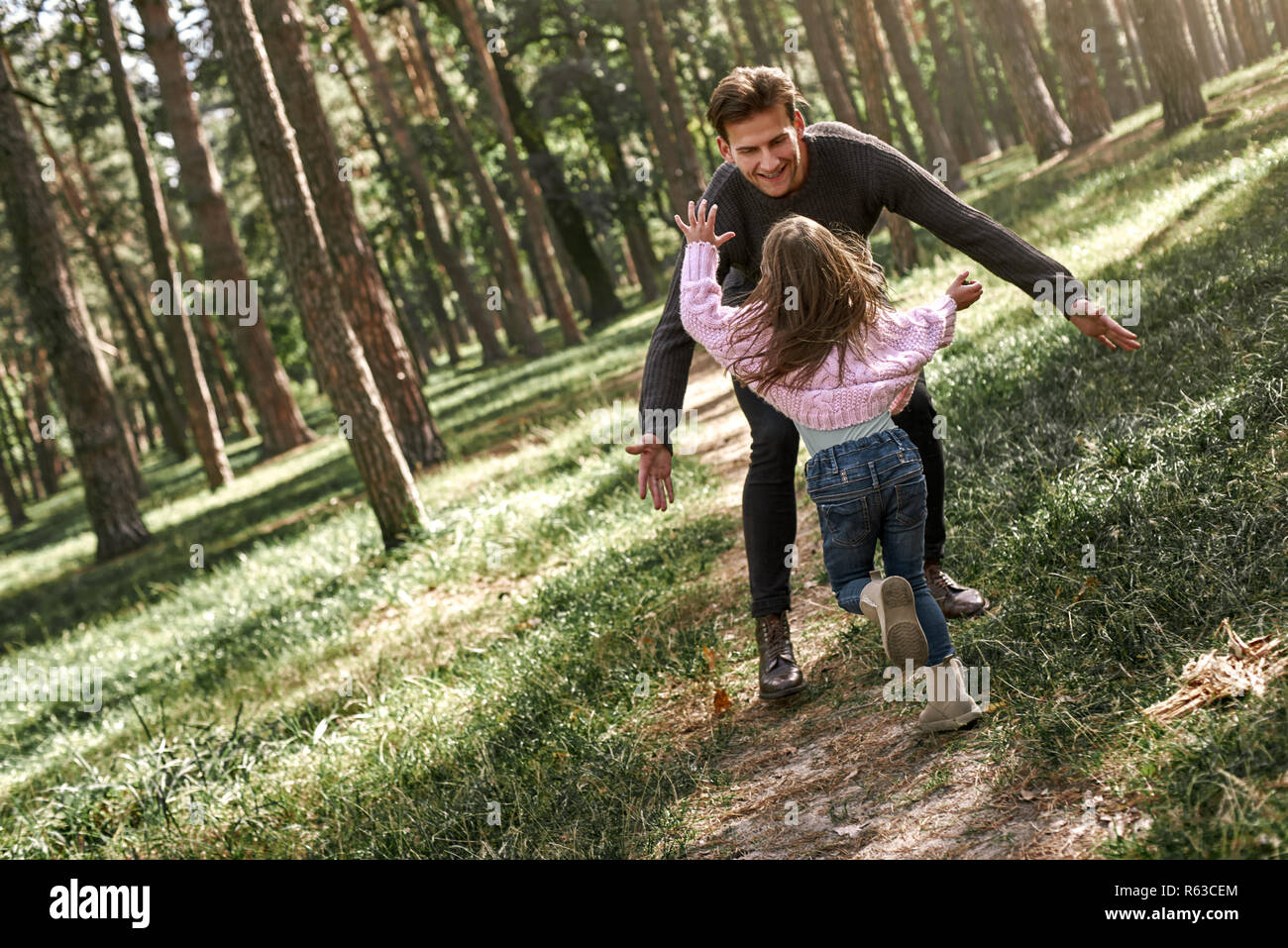 Father and daughter walking together in the forest. Full length Stock ...