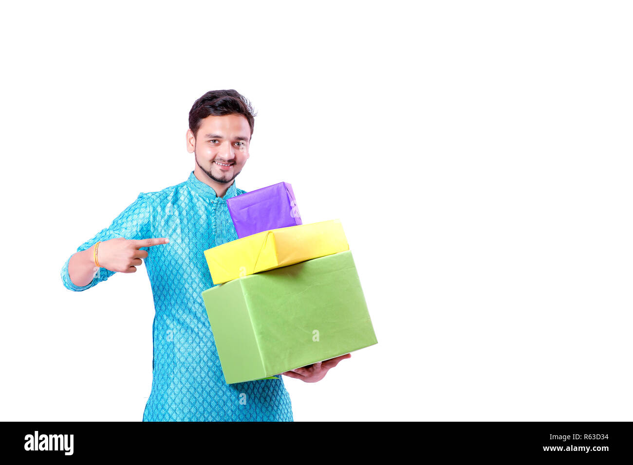 Indian man in ethnic wear and Holding gift box in hand , isolated over white background Stock Photo