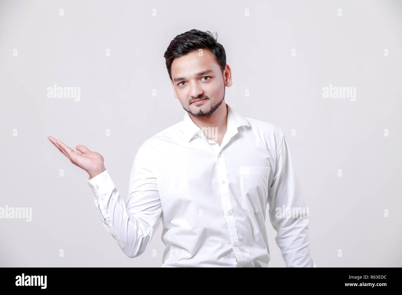 Young Indian man showing on white background Stock Photo