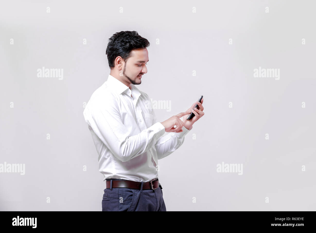 Young indian man using mobile Stock Photo
