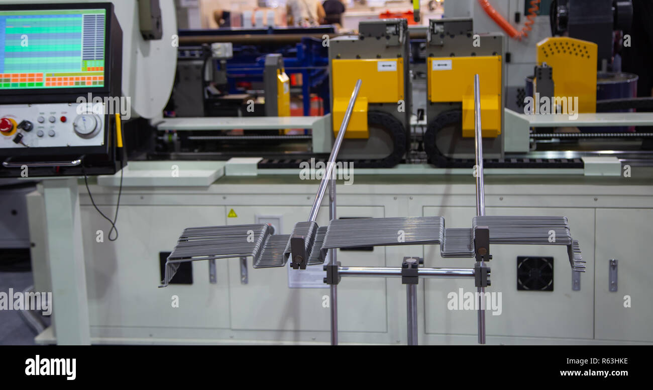 Workpieces of steel rod on automatic CNC bending machine Stock Photo Alamy